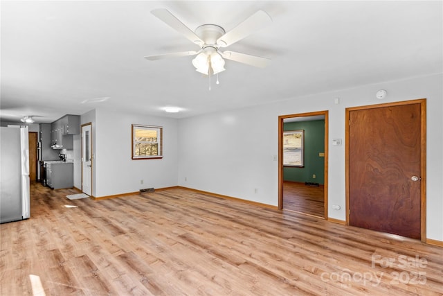 unfurnished living room featuring ceiling fan and light wood-type flooring