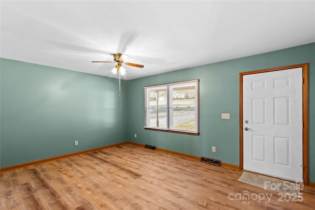 unfurnished room with ceiling fan and light wood-type flooring