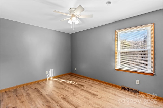 empty room featuring light hardwood / wood-style flooring and ceiling fan