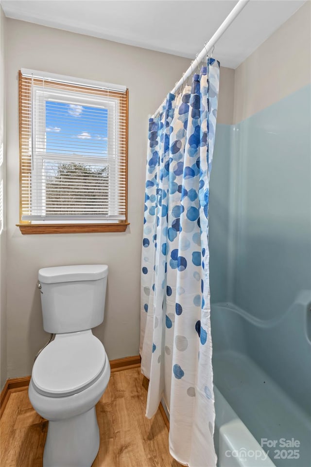 bathroom featuring wood-type flooring, toilet, and walk in shower