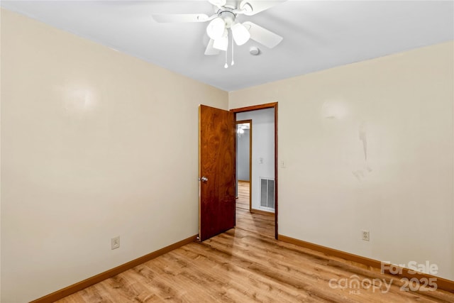 empty room with ceiling fan and light wood-type flooring