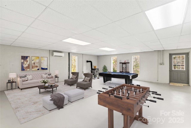 playroom featuring a wall unit AC, a paneled ceiling, and billiards