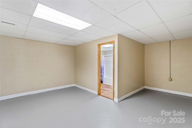 basement featuring a paneled ceiling