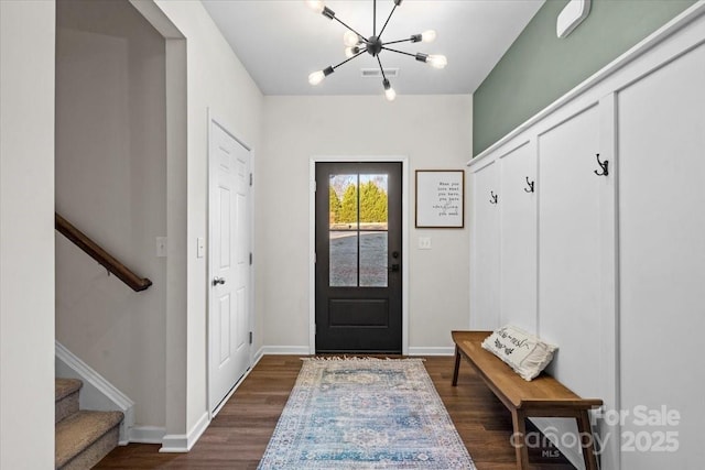 entrance foyer with a chandelier and dark hardwood / wood-style floors