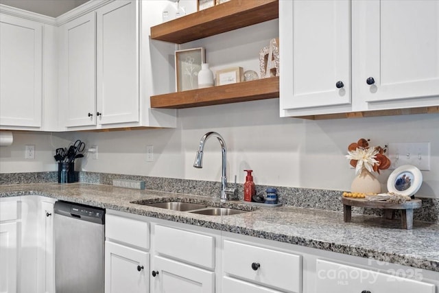 kitchen with light stone counters, sink, white cabinets, and dishwasher