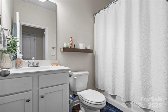 full bathroom with toilet, vanity, and shower / tub combo with curtain