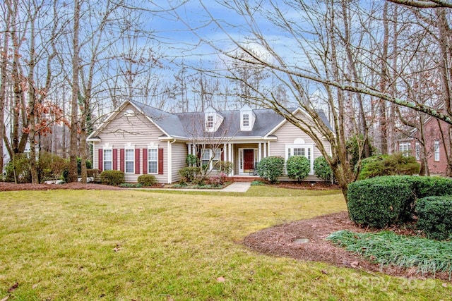 cape cod home featuring covered porch and a front lawn