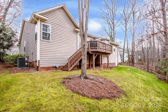 back of property featuring a wooden deck, a yard, and central AC unit