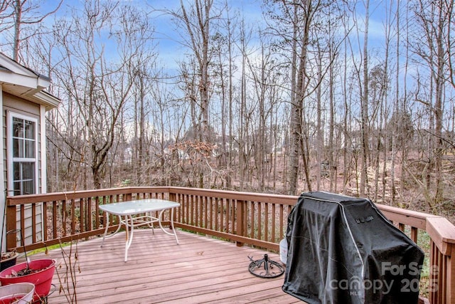 wooden deck featuring a grill