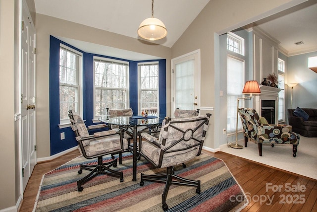 sitting room featuring crown molding, wood-type flooring, and vaulted ceiling