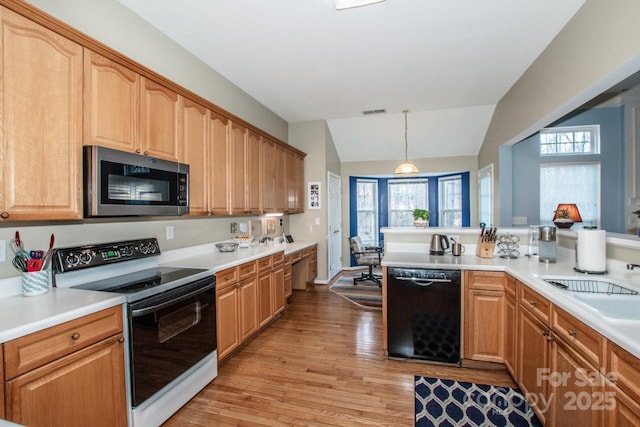 kitchen featuring pendant lighting, lofted ceiling, light hardwood / wood-style flooring, range with electric cooktop, and black dishwasher