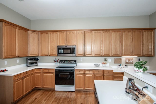 kitchen featuring light hardwood / wood-style floors and electric stove