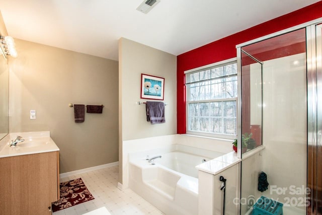 bathroom featuring vanity and independent shower and bath