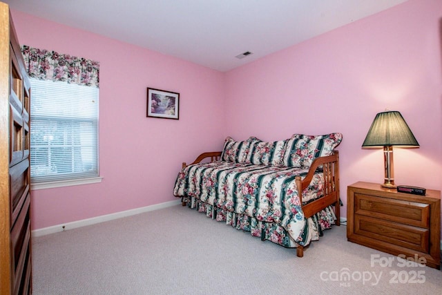 bedroom featuring light carpet