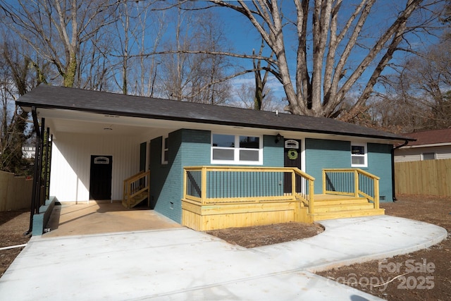 ranch-style home featuring a carport and covered porch