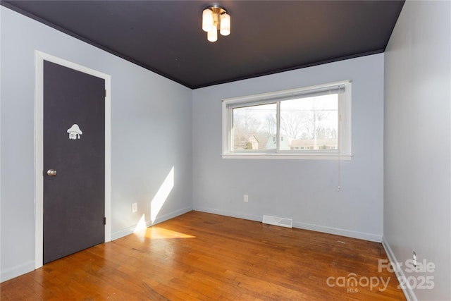 unfurnished room featuring wood-type flooring