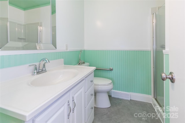 bathroom with walk in shower, vanity, and toilet