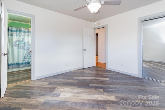 unfurnished bedroom featuring crown molding, dark wood-type flooring, ceiling fan, and ensuite bath