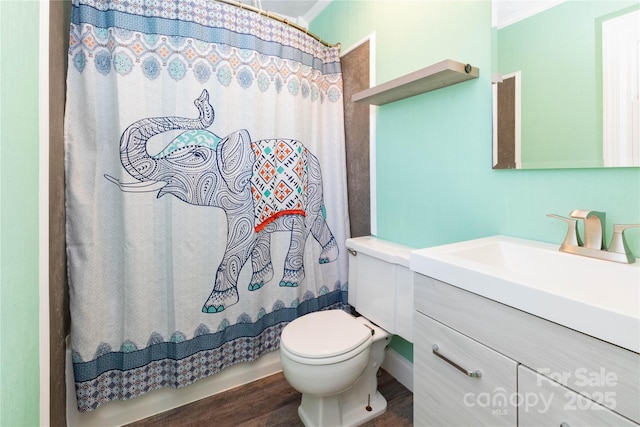 bathroom with hardwood / wood-style flooring, vanity, ornamental molding, a shower with curtain, and toilet