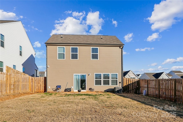 rear view of property with a lawn, a patio, and central AC