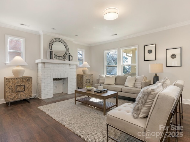 living room featuring a brick fireplace, dark hardwood / wood-style floors, and crown molding