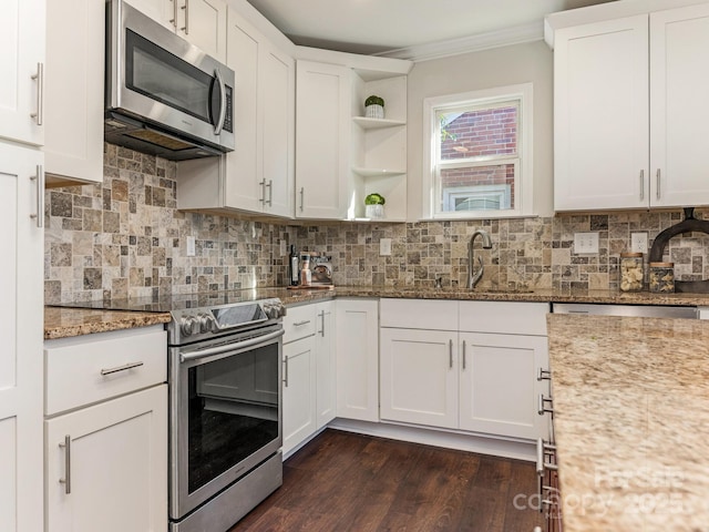 kitchen featuring light stone counters, white cabinetry, and stainless steel appliances