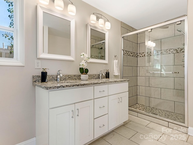 bathroom featuring vanity, tile patterned flooring, and an enclosed shower