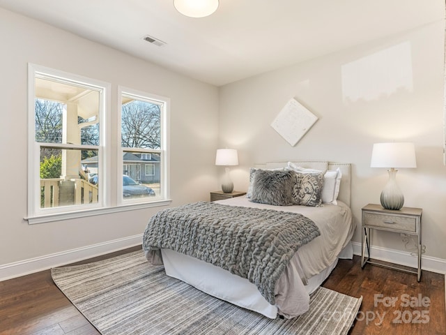 bedroom with dark hardwood / wood-style flooring