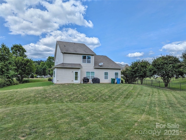 rear view of property featuring a yard