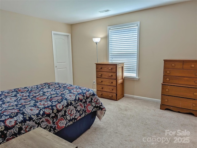 bedroom with multiple windows and light carpet