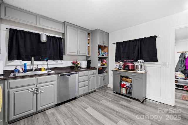 kitchen featuring gray cabinets, dishwasher, light hardwood / wood-style floors, and sink