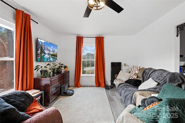 living room with ceiling fan and light hardwood / wood-style flooring