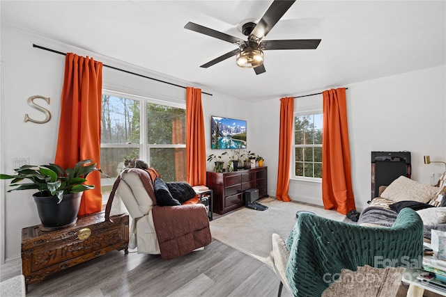 living room featuring light hardwood / wood-style floors and ceiling fan