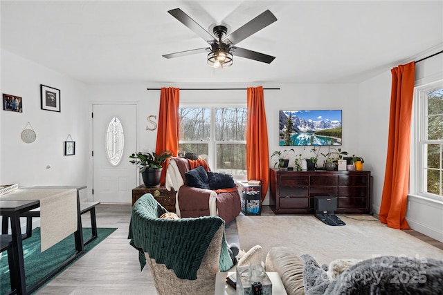 living room with ceiling fan, light hardwood / wood-style floors, and a healthy amount of sunlight