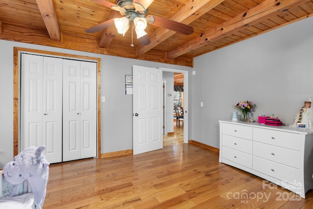 bedroom featuring beamed ceiling, wood ceiling, baseboards, and light wood finished floors