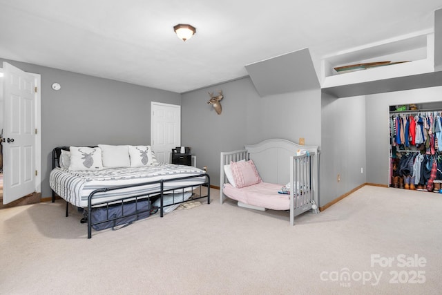 bedroom featuring a closet, baseboards, and carpet