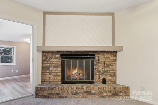 interior details with carpet flooring and a fireplace