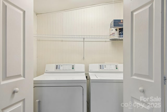 clothes washing area featuring washer and clothes dryer