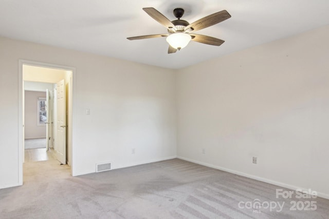 unfurnished room featuring ceiling fan and light colored carpet