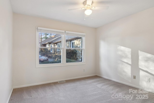 empty room featuring light carpet and ceiling fan