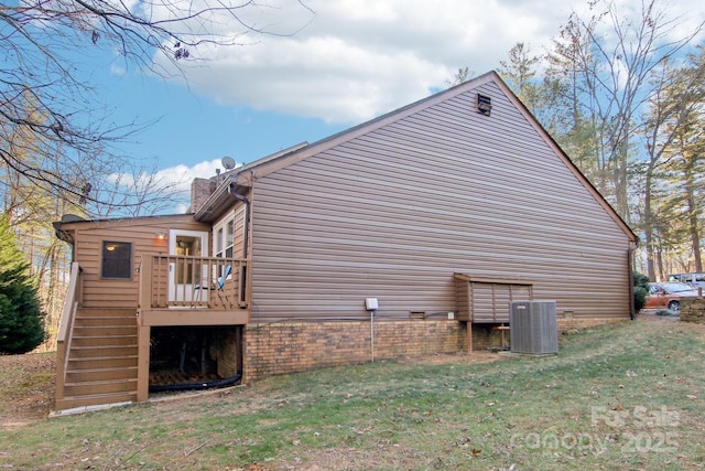 view of side of property with a lawn and central air condition unit