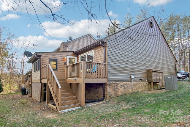 view of home's exterior featuring a yard, a deck, and central air condition unit