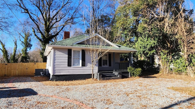 view of front of home with a porch and central AC