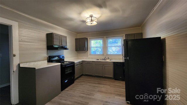 kitchen with gray cabinetry, black appliances, sink, ornamental molding, and light hardwood / wood-style floors