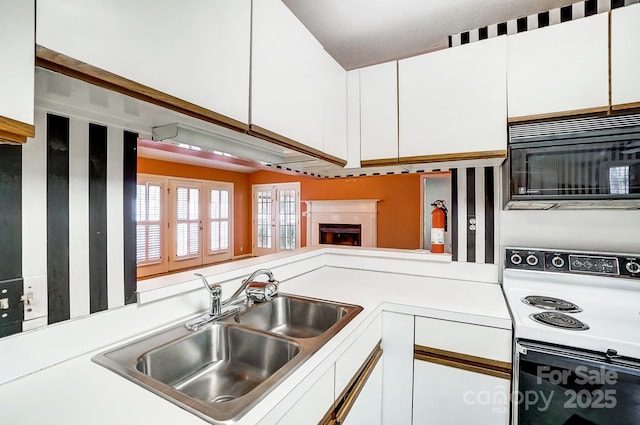 kitchen with white cabinetry, white range with electric stovetop, and sink