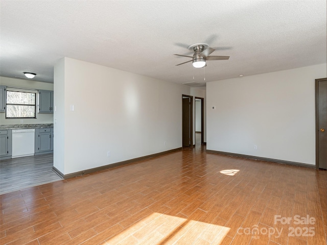 unfurnished room featuring ceiling fan and a textured ceiling