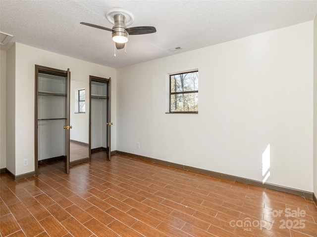 unfurnished bedroom featuring ceiling fan and a textured ceiling