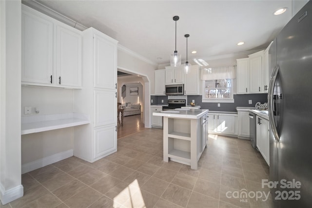 kitchen with open shelves, arched walkways, stainless steel appliances, and white cabinets