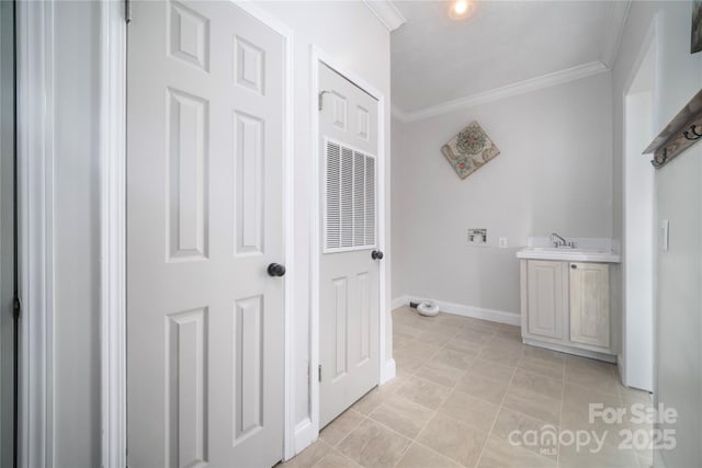 interior space with tile patterned flooring, baseboards, crown molding, and vanity