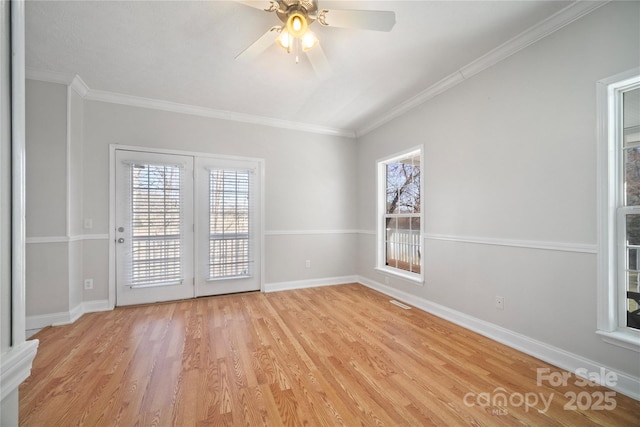 spare room featuring crown molding, light wood-style flooring, baseboards, and ceiling fan